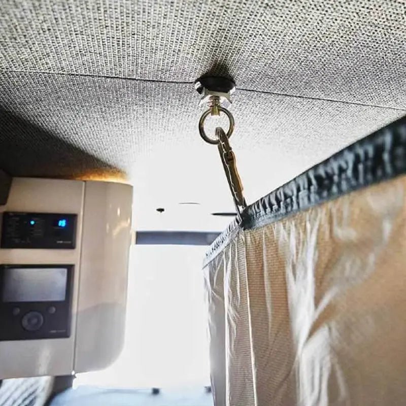 Close-up of portable shower curtain hooked securely to a van ceiling mount.