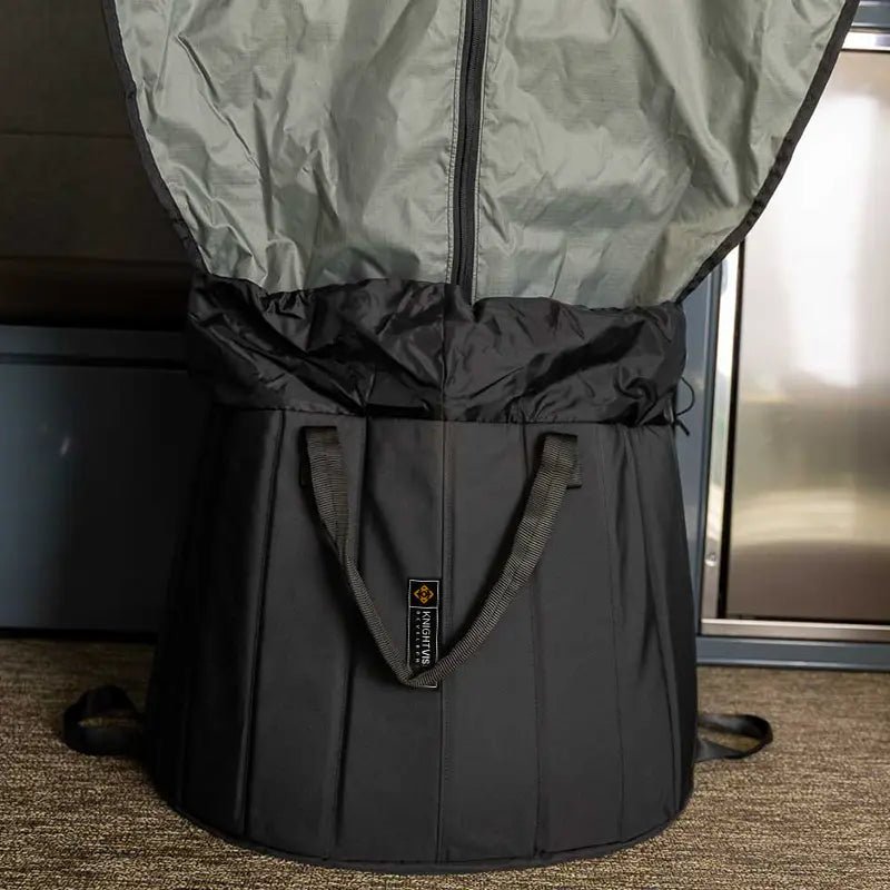 Close-up of the black portable shower basin with curtain partially attached, sitting on van floor.