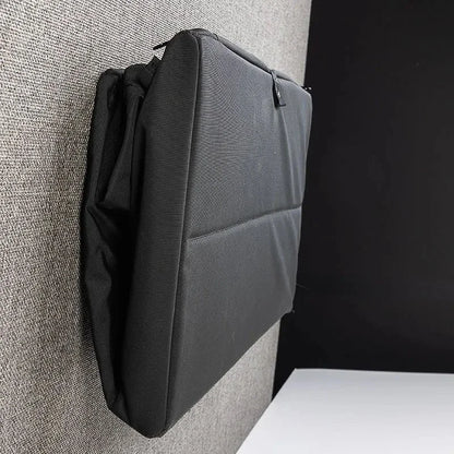 Side view of folded black cabinet stowed against a van wall in compact form.
