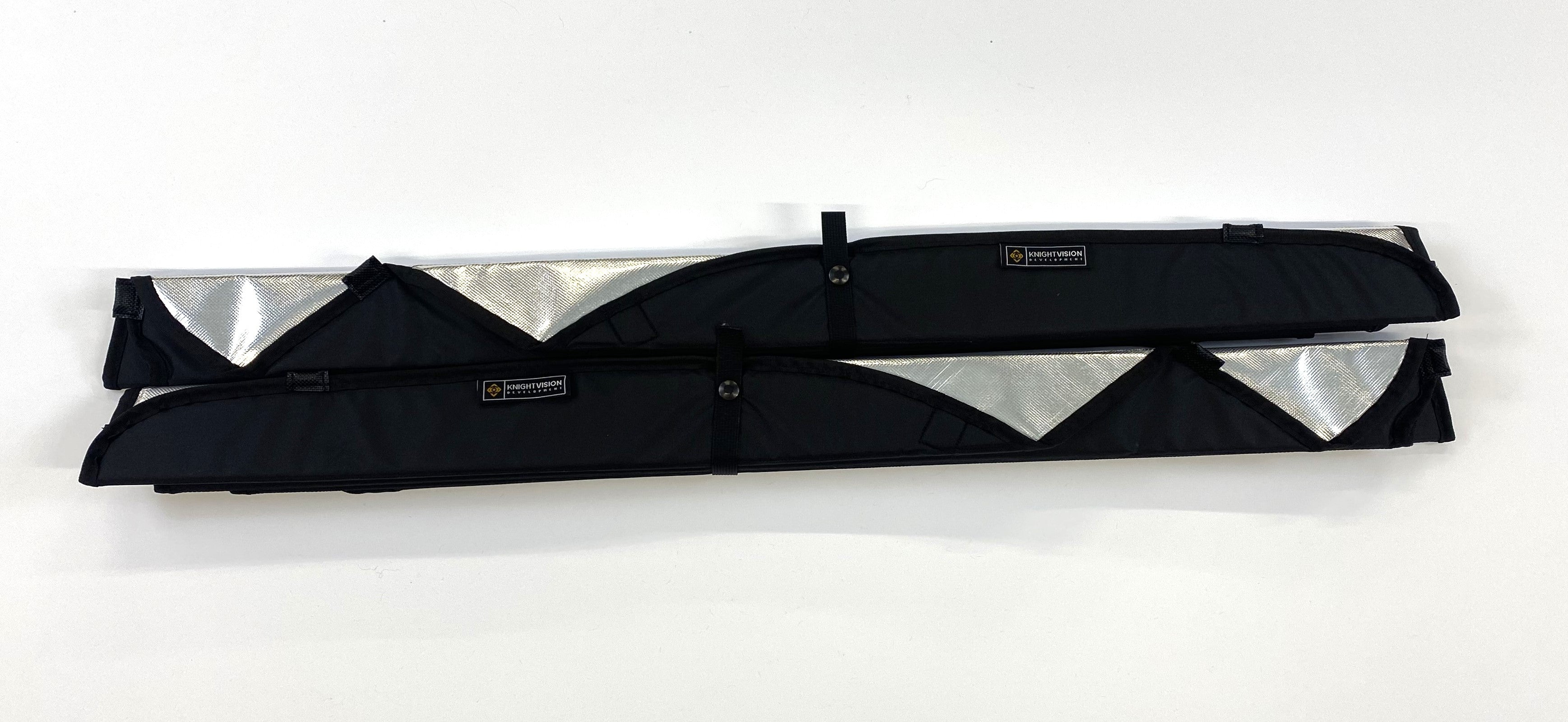 Two rolled-up reflective window covers with black fabric backing and Knight Vision branded straps for secure storage.