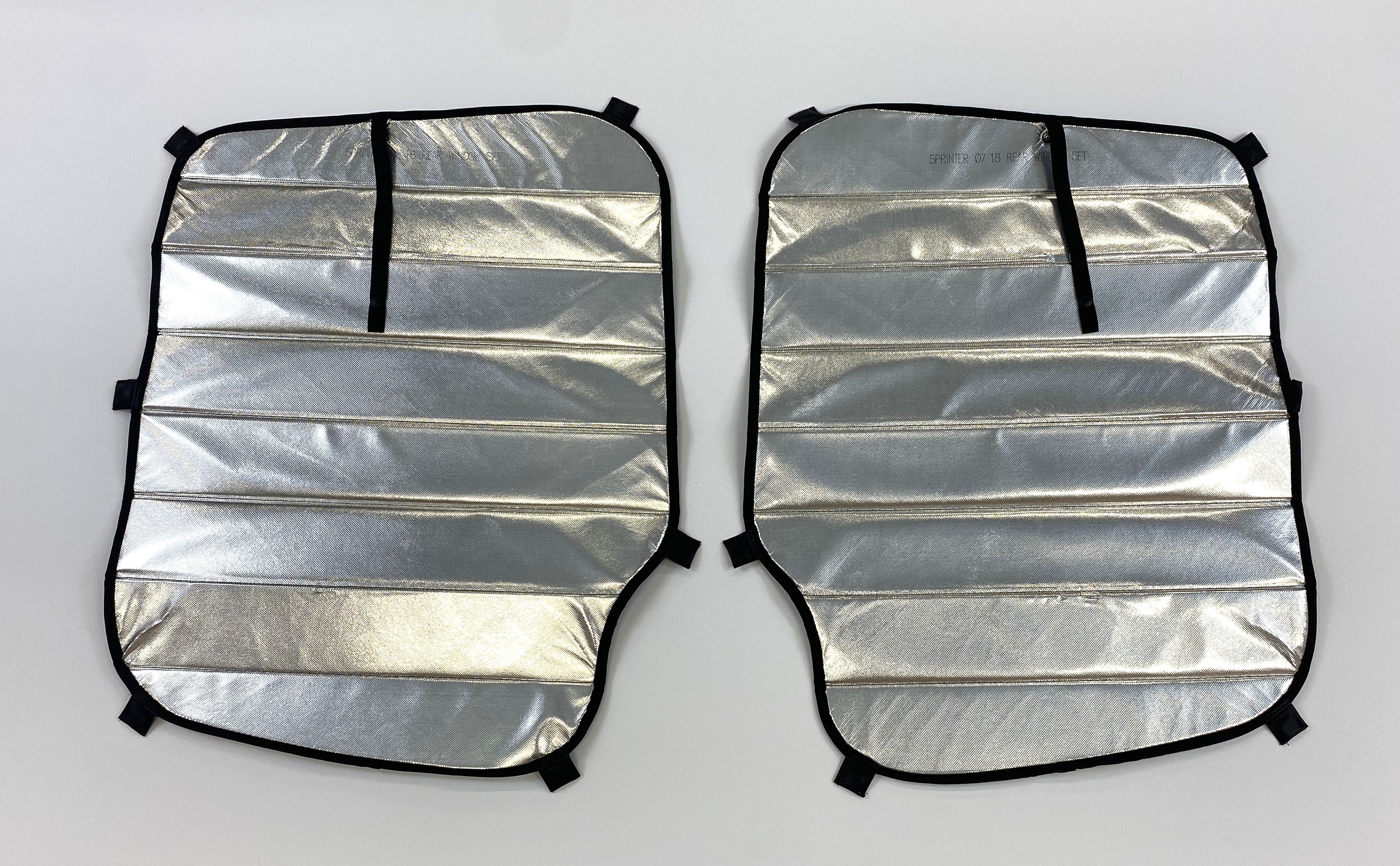 Pair of reflective insulated window covers for a Sprinter van (07–18), labeled "Rear Passenger Set." Designed with black edge binding, stitched padding, and attachment tabs for easy installation.