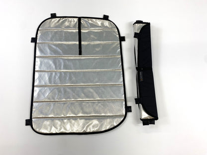 Folded and unfolded reflective window covers with black trim and integrated straps for compact storage