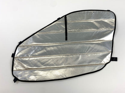 Reflective insulated van window cover with black trim and attachment straps on white background