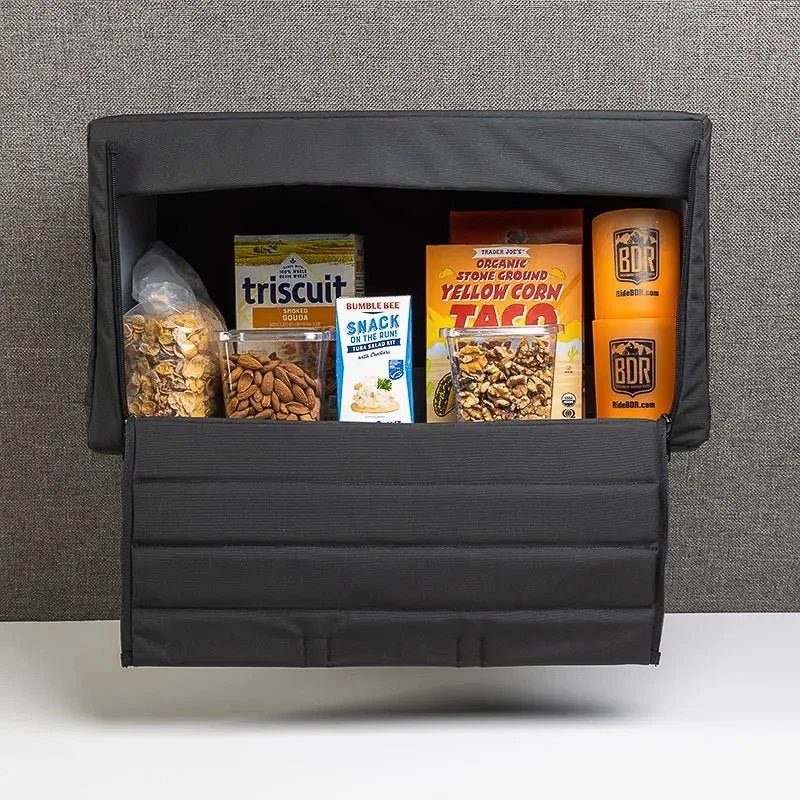 Sprinter van cabinet open and stocked with snacks, crackers, nuts, and cups inside.