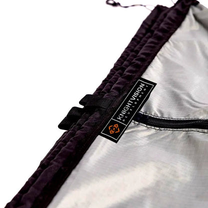 Close-up of the Knight Vision Development logo and zipper on the portable shower curtain material.